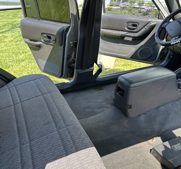 Jeep Cherokee interior with clean carpet and reinstalled rear seat after detailing