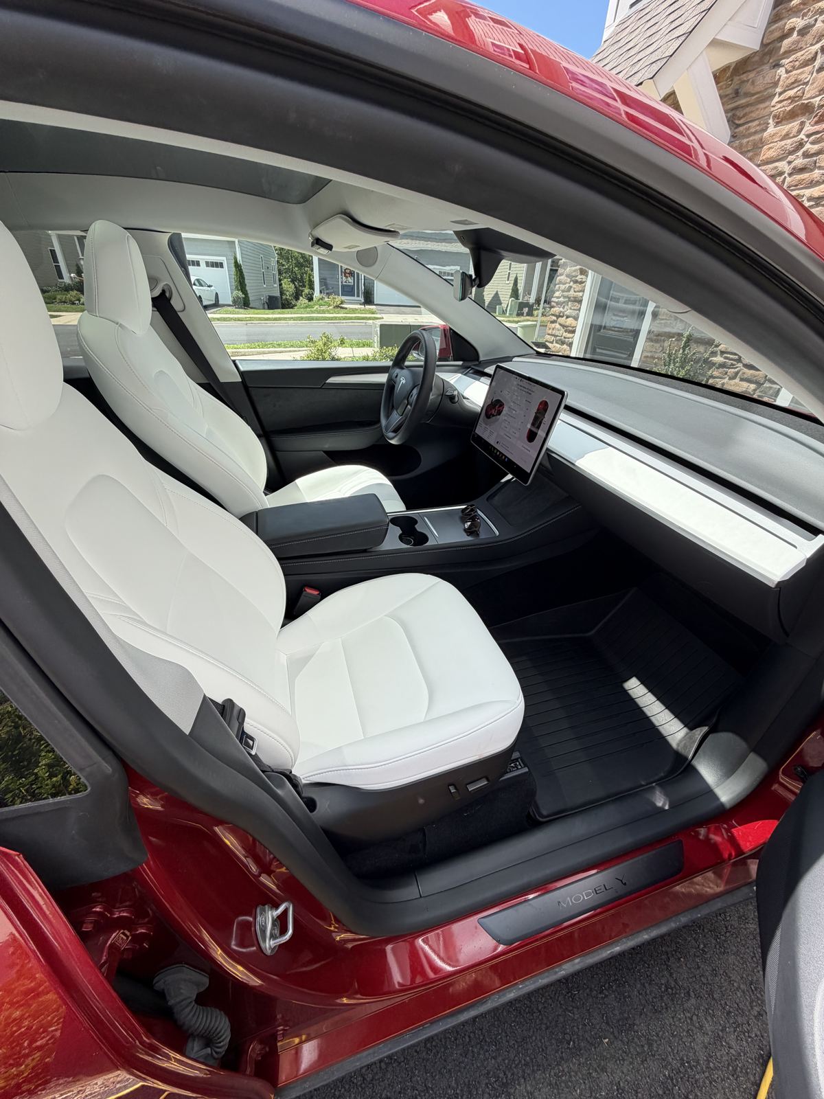 Tesla Model Y front seats and floor mats after interior detail